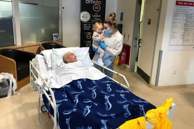 Paul Kempton meeting his granddaughter Millie for the first time, with Ella