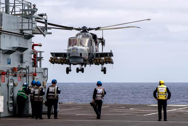 Aircraft handlers watch the Wildcat fully armed with 20 Martlets.