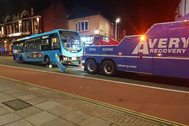 The damaged bus being put onto a recovery vehicle in London Road, Hilsea, at 8.17pm last night.