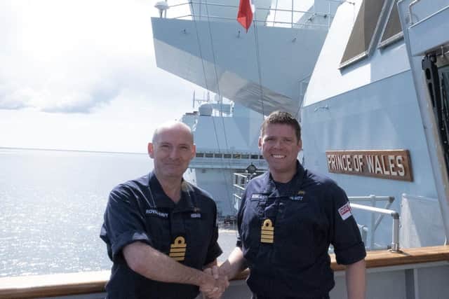 Captain Steve Higham, left, pictured handing over command of HMS Prince of Wales to Captain Richard Hewitt