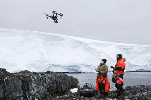 Pictured: Lt Cdr Kate Retallick and LMet Ross Lovejoy flying a drone to collect aerial imagery of the penguin colony. HMS Protector collected imagery of penguin colonies on Jingle, Smigger and Fizkin Islands, part of the Pitt Islands. Photo: LPhot Belinda Alker/Royal Navy.