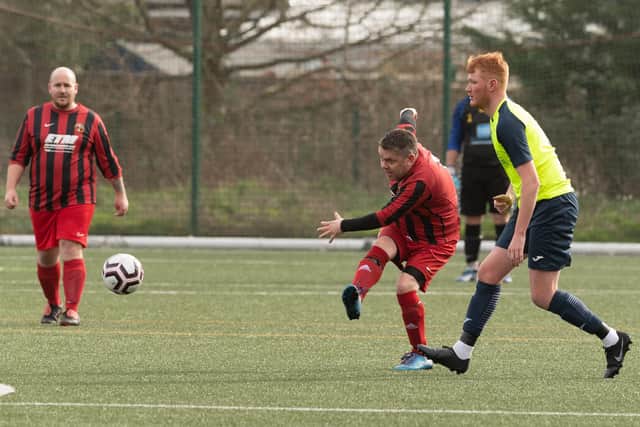 A Horndean player fires in a shot at goal against Harvest Home. Picture: Keith Woodland
