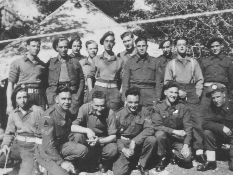Soldiers of 1st Battalion, South Lancashire Regiment, in a camp waiting for D-Day. They are probably at Camp A5 at Padnell or Camp A6 at Queen's Inclosure [in the Cowplain-Waterlooville Official area]. They landed on Sword Beach on D-Day. These camps were mostly formed from tents, and one can be seen behind.