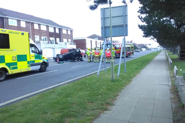 Emergency service crews have been called to a car overturned by a crash along Hayling Island's Sea Front Road.