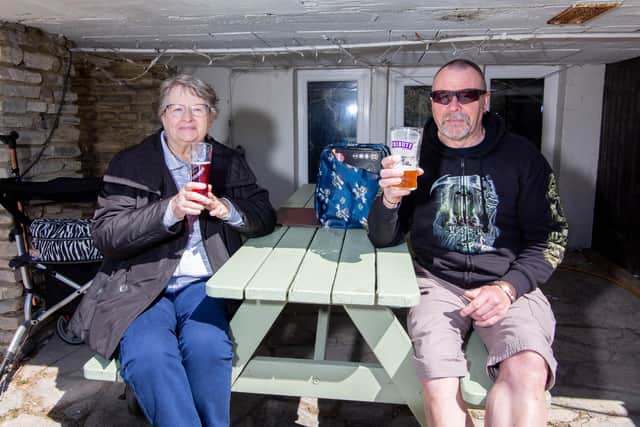 Lin and Aron Carrott enjoy the sunshine outside The Jolly Sailor. Picture: Habibur Rahman