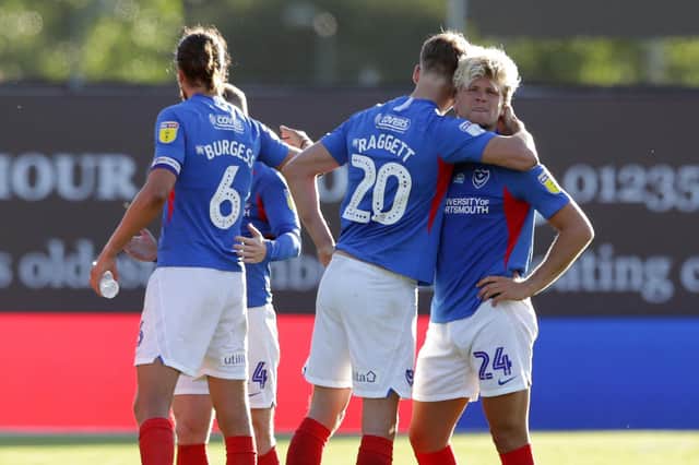 Pompey's players console Cameron McGeehan at the end of their penalty shoot-out defeat at Oxford United. Picture: Robin Jones/Getty Images