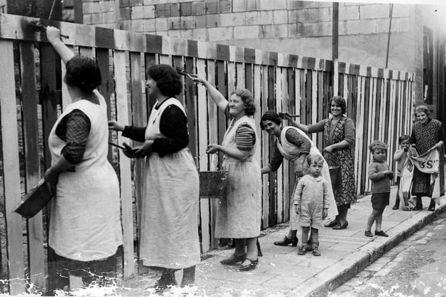 Getting ready for the King.Pictured in 1937 are ladies from Nile Street, Landport  painting a fence in the colours of the Union jack for the celebrations for the Coronation of King George VI in 1937.Sent in by George Warren of Horndean we see from left to right Mrs Lilly, Mrs sands, Mrs Russell and George's mother, Mabel.  Far right is George with his grandmother.