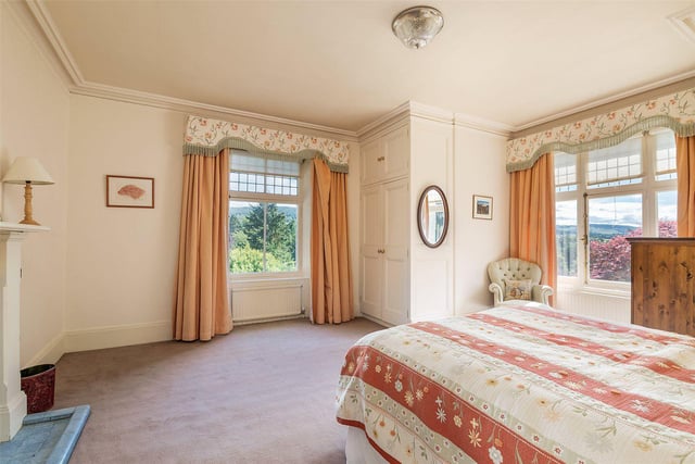 One of the four bedrooms, which has views of the garden.