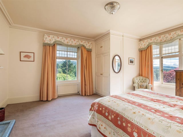 One of the four bedrooms, which has views of the garden.