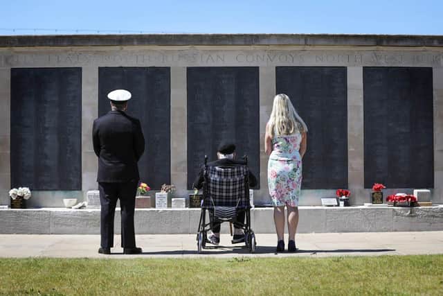 Lawrence Churcher, 99, pictured saluting with Lieutenant Calvin Shenton and another supporter Photo: PO Arron Hoare
