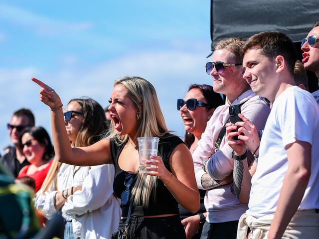 The crowds cheer on the contestants of the chilli eating contest.