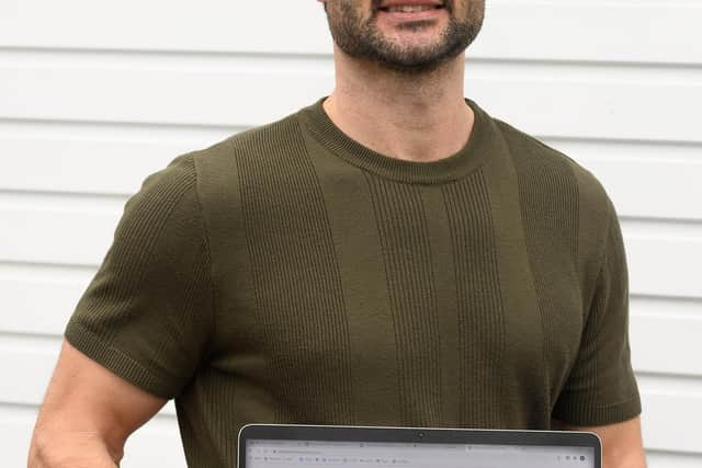 Michael Newman with his laptop displaying his website.

Picture: Keith Woodland (300120-4)