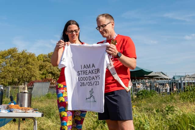 Miles van der Lugt and partner Gillian Horn with a special 'comma' day t-shirt. Picture: Mike Cooter