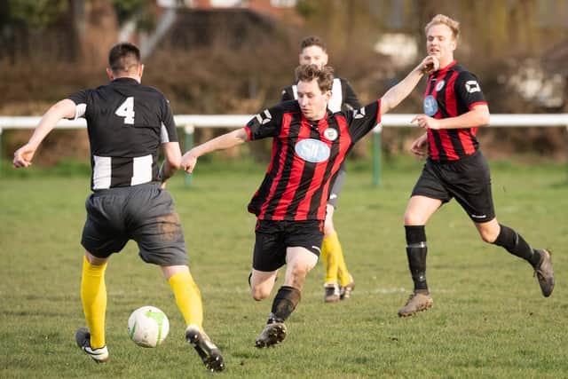 Locks Heath (red/black) in action during their 5-0 home loss to Hayling United on March 15, which turned out to be their last game of the season. Picture: Keith Woodland