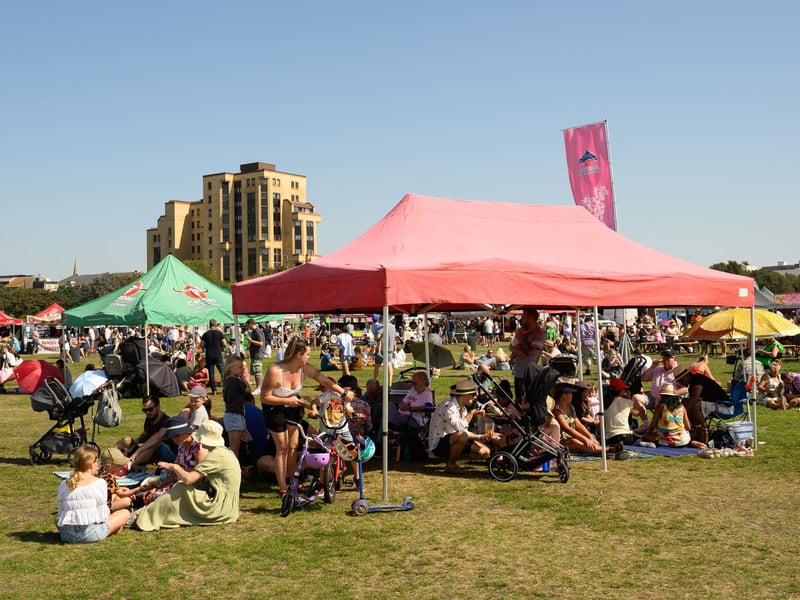 Pictured is: Visitors take shade at the Thai Food Festival.
Picture: Keith Woodland (090921-64)