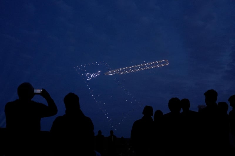 Drones make a pen and paper during a drone display telling the story of D-Day. Photo: Andrew Matthews/PA Wire
