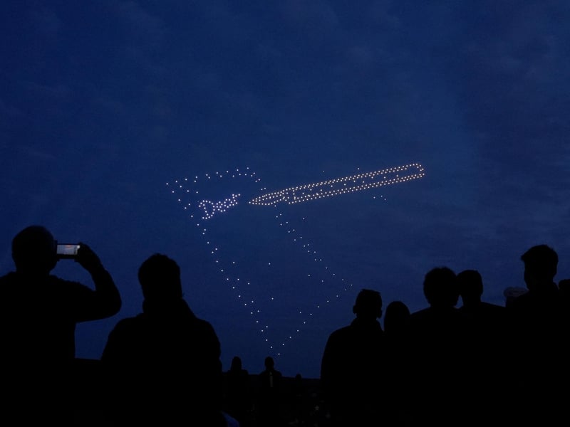 Drones make a pen and paper during a drone display telling the story of D-Day. Photo: Andrew Matthews/PA Wire
