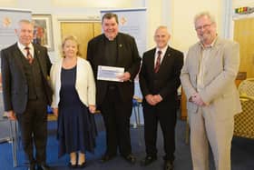 Fr Bob White accepts a £6,000 cheque for the Portsmouth Community Housing Trust as the final cash give-away from the Community Chest initiative run by Hampshire and Isle of Wight Freemasons and The News. Pictured with Fr Bob, left to right, are Graham Lant, Sue Lant, Andrew Coombs and Colin Rattley, whose fundraising raffles during lockdown led to the Communiuty Chest being launched. Picture: Ross Lucas-Young