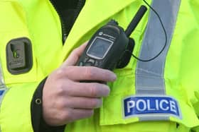 Police officer using a radio. Picture: David Cheskin/PA Wire