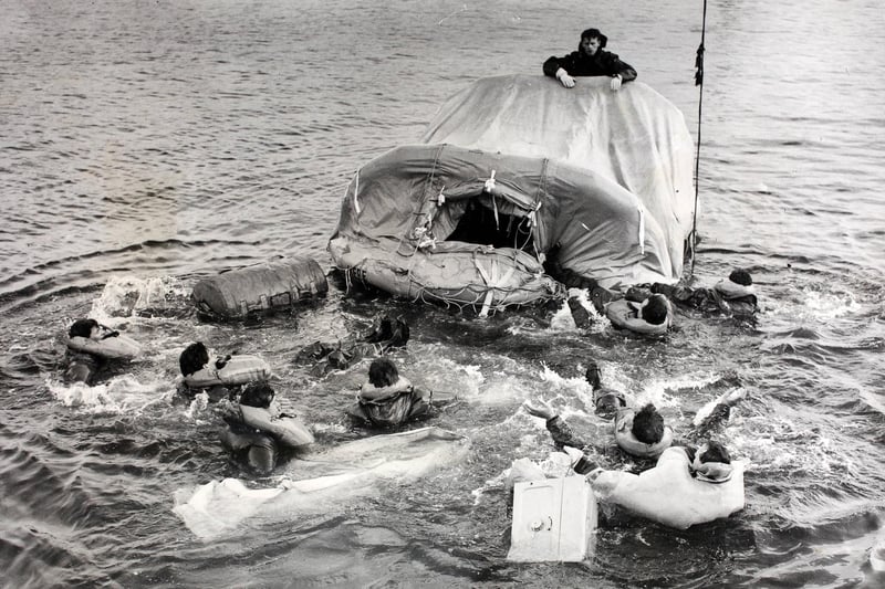 Survivors' scrambling onto an inflatable raft during the trials to test new types of hydrostatic release unit for improved inflatable life rafts for the Royal Navy at Portsmouth, UK. (Photo by Hulton Archive/Getty Images)