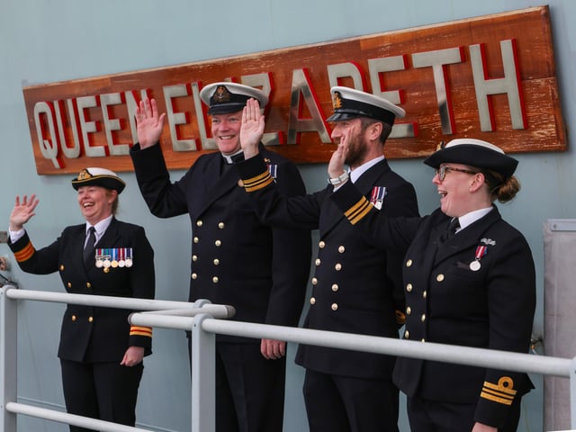Ship's company and embarked personnel wave to families and friends as the ship returns to Portsmouth after a 7 month deployment in 2021.