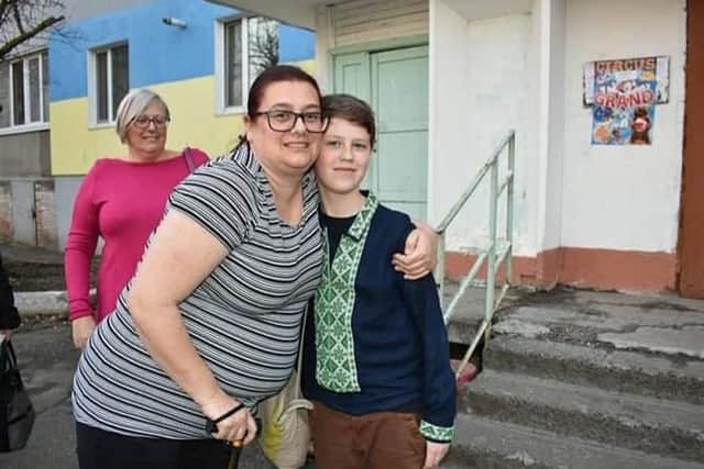 Jo Cullimore with her arm around Illia Berdnikov, in the town of Borodyanka, northern Ukraine. Jo Cullimore, who has spent a decade helping Chernobyl children, said it is 'heart breaking' to see the town where she worked being destroyed by the Russian army. Picture: Jo Cullimore/PA Wire.