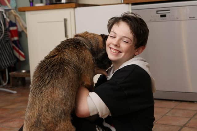 Delighted Samuel Brotherton pictured with his dog Melchy less than a day after two men pushed him to the ground and stole the dog in Horndean. Picture: Habibur Rahman