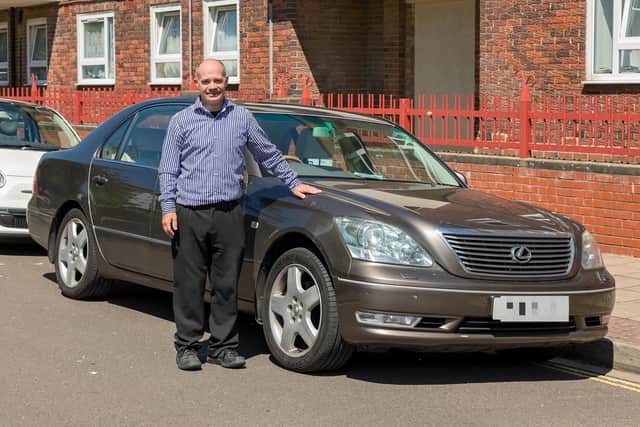Rusty Brown, who sustained life changing injuries after a traffic accident, pictured with his specially adapted car. Picture: Mike Cooter (090621)