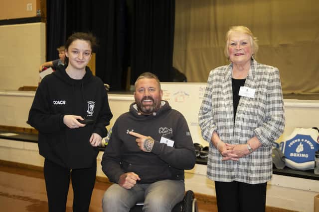 Shania Harris receives an award with Heart of Hayling Boxing Academy coach Knox White and Hayling councillor and trustee Leah Turner also pictured