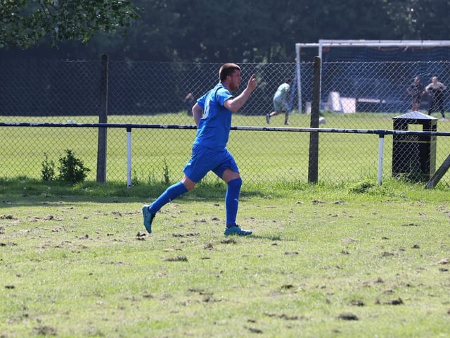 Joe Boxall (blue) has just scored Paulsgrove's winner against Clanfield. Picture: Sam Stephenson.