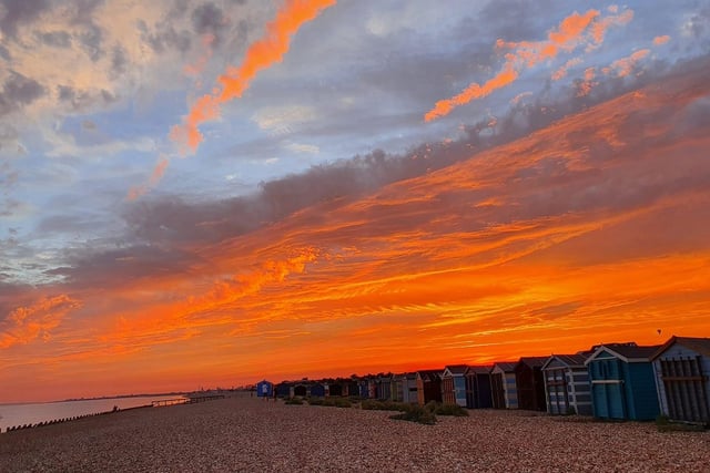 The orange sunset over the beach huts on Hayling Island. Credit: Barbara Fletcher Colson.