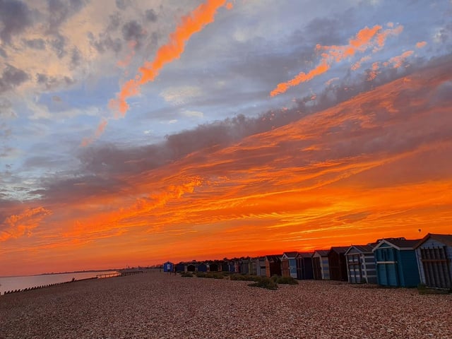 The orange sunset over the beach huts on Hayling Island. Credit: Barbara Fletcher Colson.