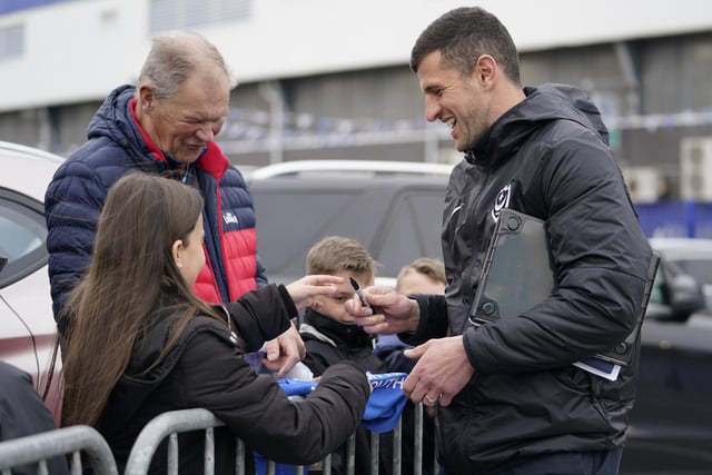 Pompey head coach John Mousinho spends some time with the fans before heading into Fratton Park.