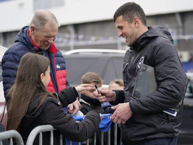 Pompey head coach John Mousinho spends some time with the fans before heading into Fratton Park.