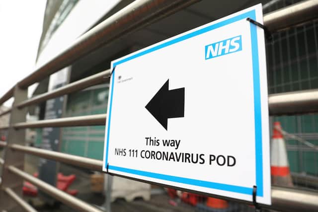 A sign directs directs patients to an NHS 111 Coronavirus Pod testing service area for COVID-19 assessment at University College Hospital in London. Picture: ISABEL INFANTES/AFP via Getty Images
