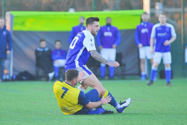 Denmead's Ryan Chandler (blue/white) in action during last weekend's 2-0 Hampshire Premier League win over leaders Moneyfields. Picture: Martyn White