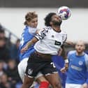 Ryley Towler tangles with ex-Pompey striker Ellis Harrison in Saturday's 2-2 draw with Port Vale. Picture: Jason Brown/ProSportsImages