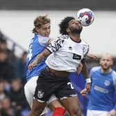 Ryley Towler tangles with ex-Pompey striker Ellis Harrison in Saturday's 2-2 draw with Port Vale. Picture: Jason Brown/ProSportsImages