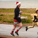 Festive runners make their way to the finishing line at the Christmas Pud 5k run at Stokes Bay, Gosport
