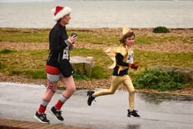 Festive runners make their way to the finishing line at the Christmas Pud 5k run at Stokes Bay, Gosport