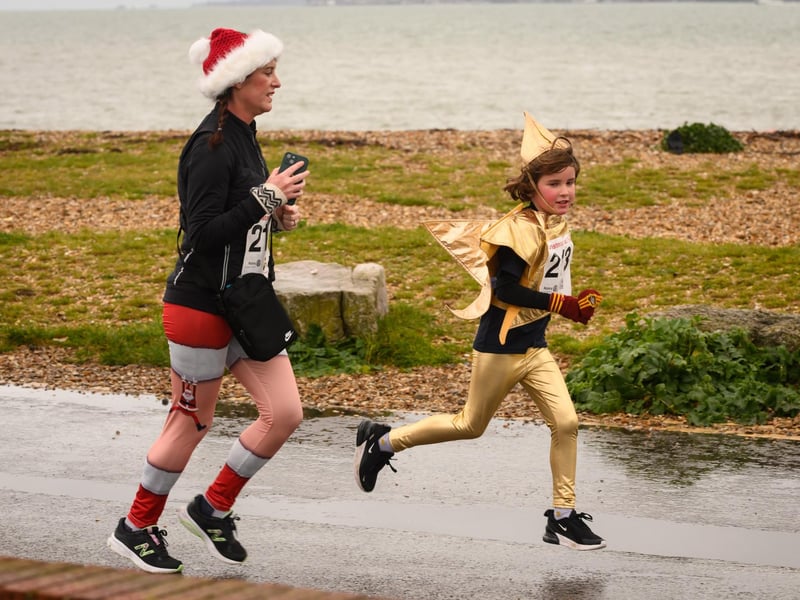 Festive runners make their way to the finishing line at the Christmas Pud 5k run at Stokes Bay, Gosport
