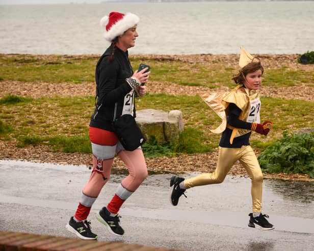 Festive runners make their way to the finishing line at the Christmas Pud 5k run at Stokes Bay, Gosport