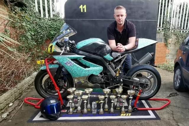Daz O'Leary with his bike and some of his silverware