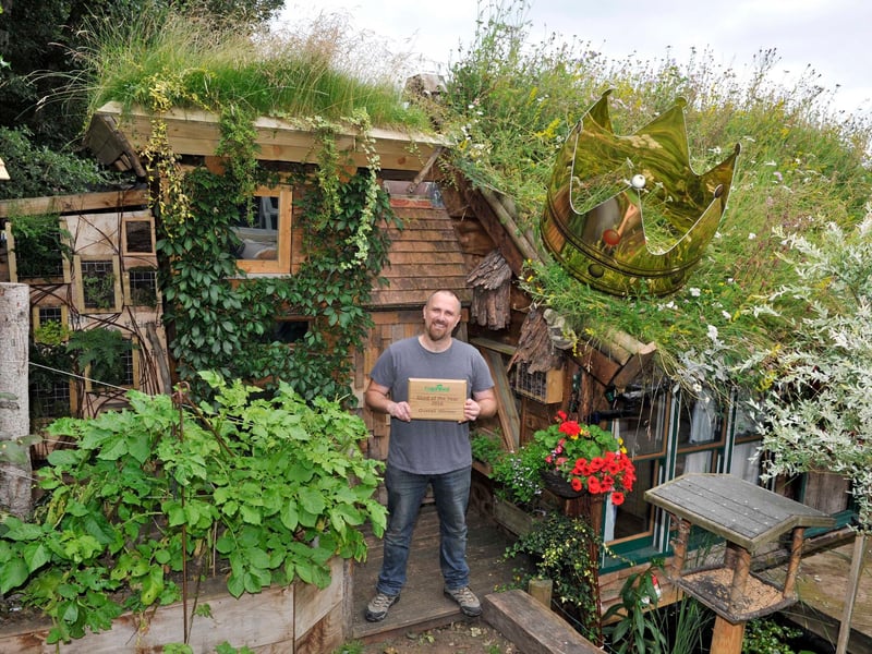 The 2016 winner - built by Kevin Herbert
It is in three sections - the largest part is for me.  It has a bed in loft space and an area to relax and escape my four kids(love them really)second part is through secret bookcase for my ten and 11 year olds to sleep and play and the last part is for storage and workshop.
My shed is made from 90% recycled materials ,It is a project that has taken me 8 years to build(health reasons - won't bore you)the roof is wild turf but because of angle I used 400 milk cartons cut in half - which took a year to collect -popped holes in and layered bottom with shingle for drainage. The two tonnes of soil and turf plopped on top.My kids helped me a lot good fun .A man needs a shed.
