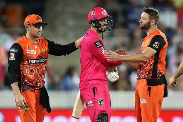 James Vince shows his frustration as he shakes hands with Andrew Tye after the latter bowled the wide that gave Sydney Sixers victory and denied Vince the chance of reaching his century. Photo by Mark Kolbe/Getty Images.