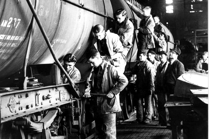 Portsmouth Dockyard workers repairing oil fuel trucks, 1940's. The News PEN 762