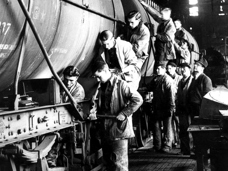 Portsmouth Dockyard workers repairing oil fuel trucks, 1940's. The News PEN 762