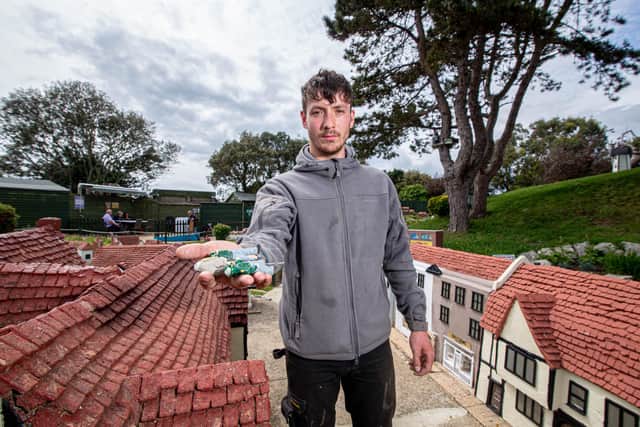 Southsea Model Village assistant manager Harry Wilson pictured last month with some of the damaged miniature figures 
Picture: Habibur Rahman