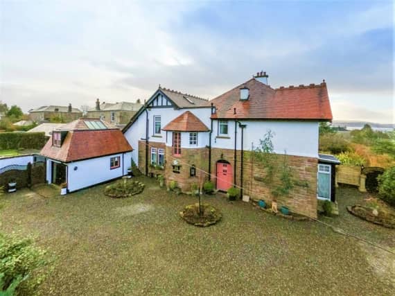 Front of property with gravelled driveway and parking area.