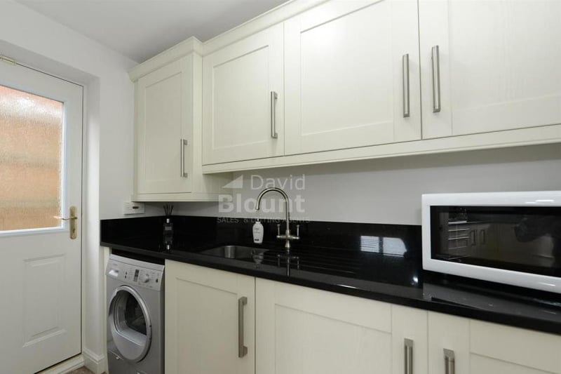 This utility room is sure to come in handy. As well as a sink and work surfaces, it includes a cupboard housing the gas central-heating boiler